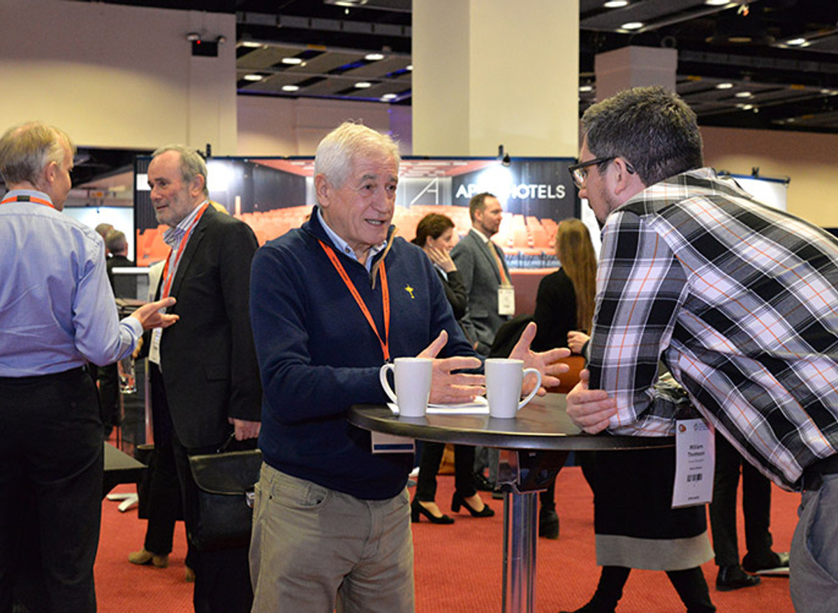 Discussion between two delegates at cocktail table